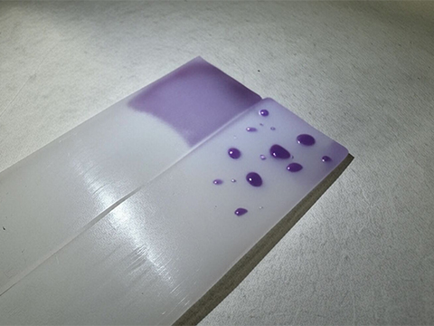 What is surface energy and how does it affect adhesive bonding?
